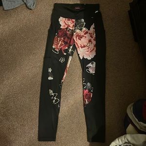 Justice Silk black leggings with flowers. Has pockets.